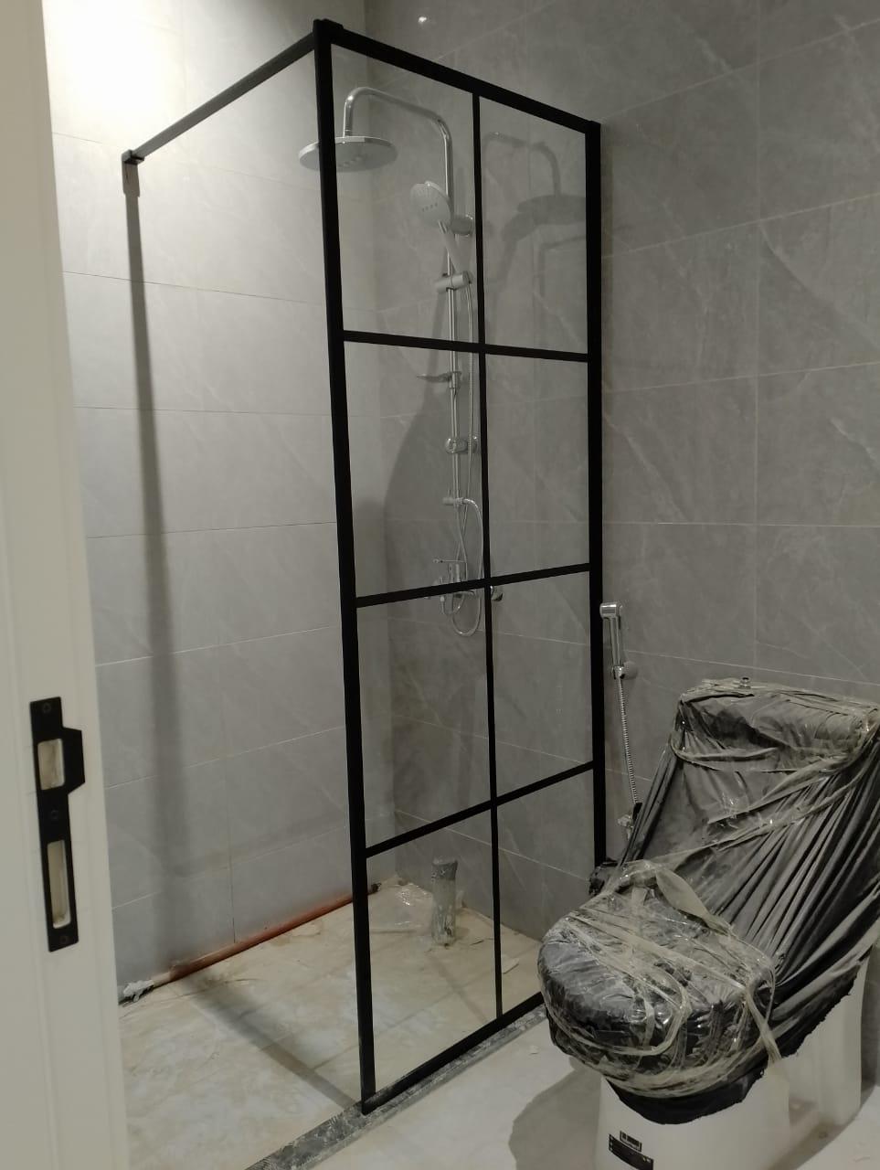 Frosted glass bathroom partition with steel hinges